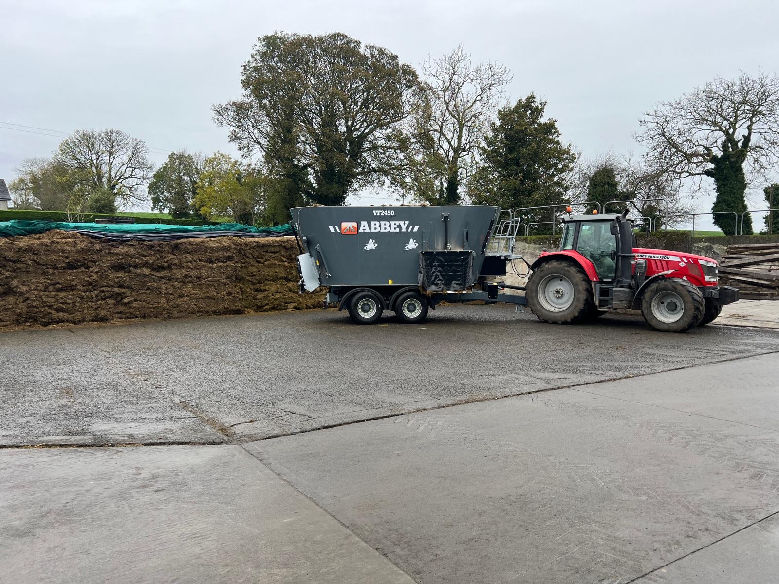Tractor and diet feeder beside the silage pit in the farmyard