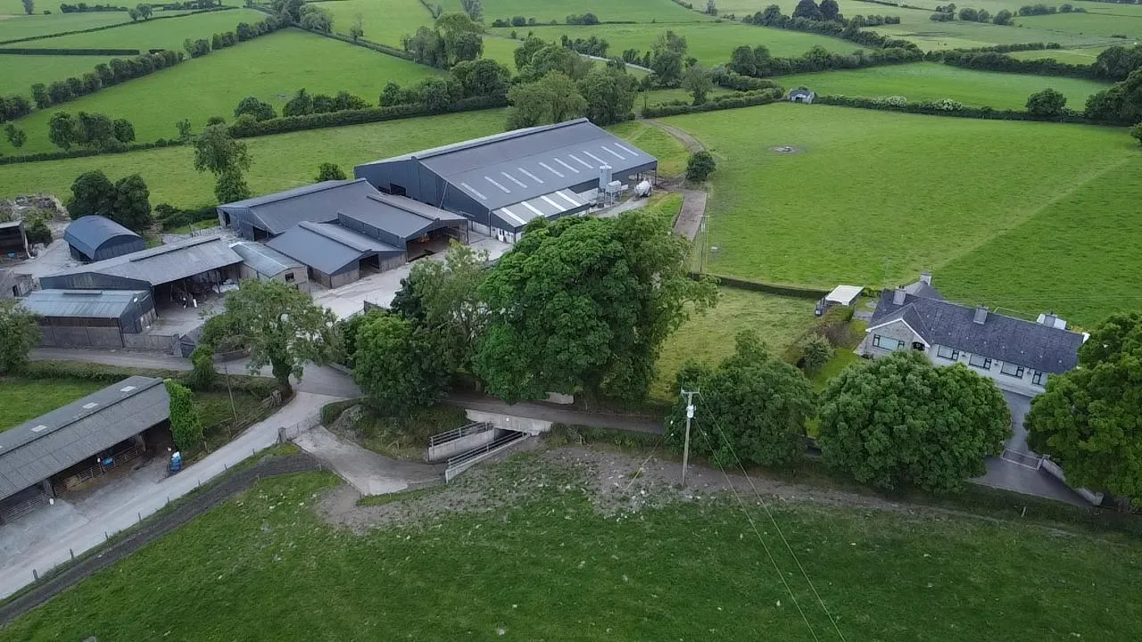 Aerial drone view of Tully farm buildings, surrounding green fields and farmhouse
