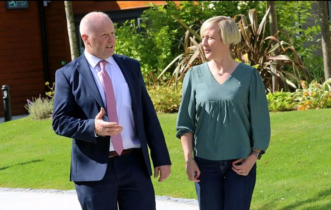 Niall Matthews in conversation outdoors, discussing dairy industry matters